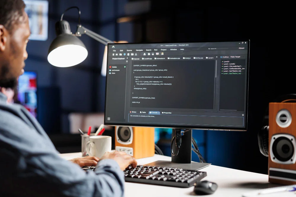 A young developer coding a website on monitor