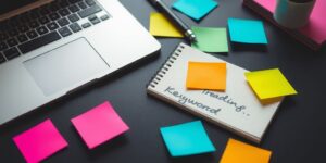 Vibrant workspace with laptop and colorful notepad.